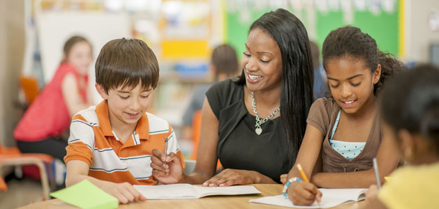 image of teacher talking with student team