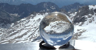 image of clear snow globe in front of alpine habitat